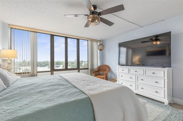 3580 S Ocean Shore Blvd Unit 210, Flagler Beach, FL 32136 - bedroom featuring a textured ceiling, ceiling fan, and baseboards