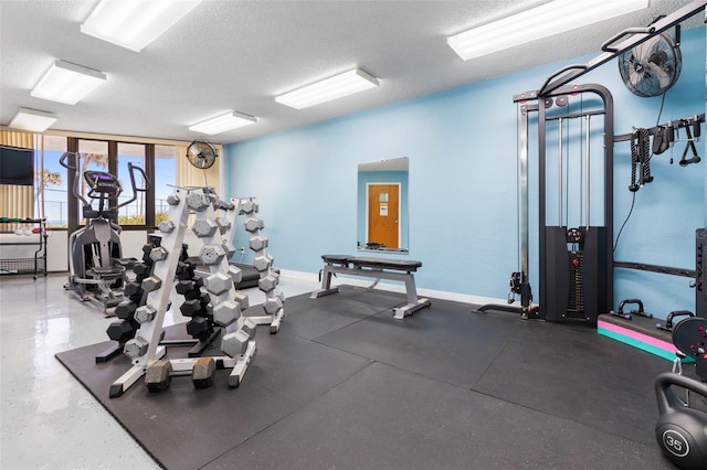 3580 S Ocean Shore Blvd Unit 210, Flagler Beach, FL 32136 - gym featuring a textured ceiling and baseboards