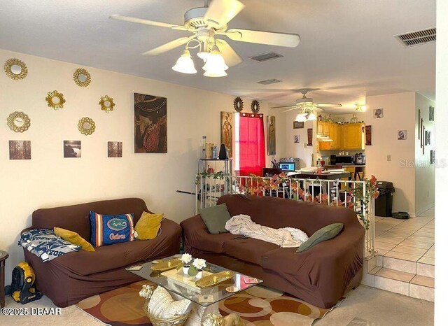 living area with a ceiling fan and light tile patterned flooring