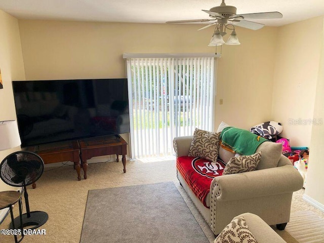 carpeted living room with a ceiling fan