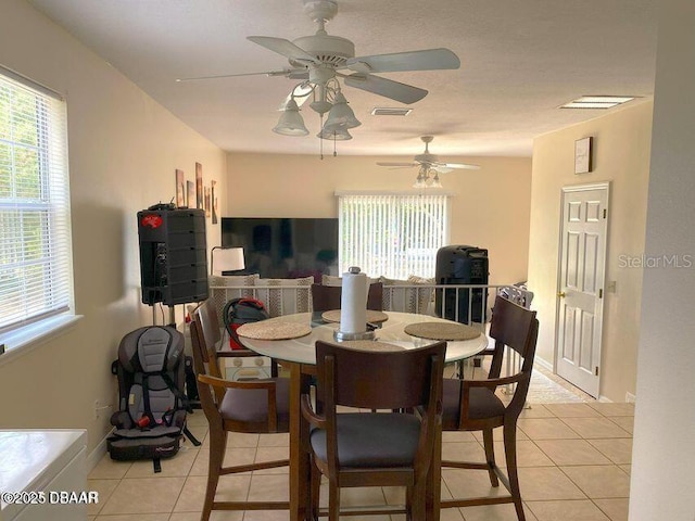 dining space with light tile patterned flooring and ceiling fan