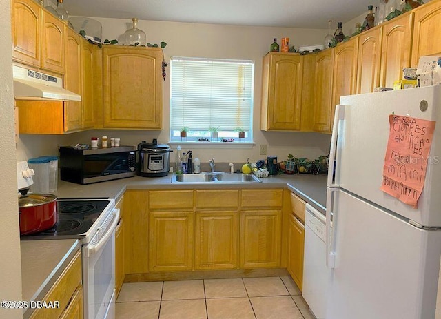 kitchen featuring white appliances, a sink, under cabinet range hood, light tile patterned floors, and light countertops