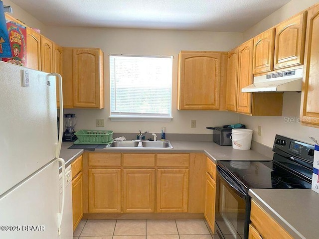 kitchen featuring freestanding refrigerator, black / electric stove, under cabinet range hood, a sink, and light tile patterned floors