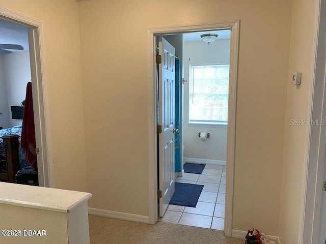 bathroom featuring baseboards and tile patterned flooring