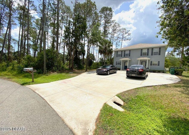 view of front of house with a front yard and driveway