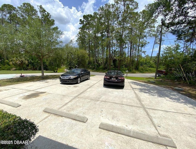 view of car parking featuring a fire pit