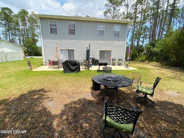 back of property with a patio and a fire pit