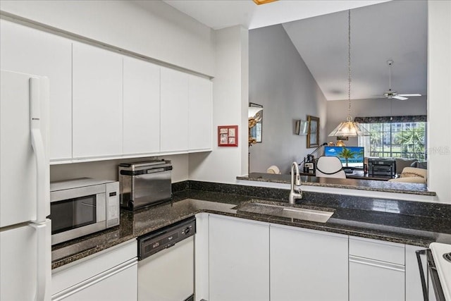 69 Rivers Edge Ln Unit 69, Palm Coast, FL 32137 - kitchen featuring white appliances, a sink, white cabinets, and dark stone counters