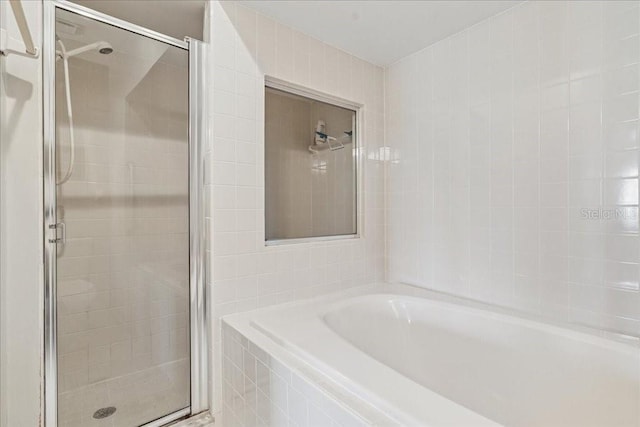 69 Rivers Edge Ln Unit 69, Palm Coast, FL 32137 - full bathroom featuring a stall shower and a bath