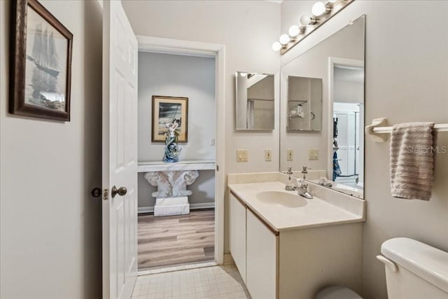 69 Rivers Edge Ln Unit 69, Palm Coast, FL 32137 - bathroom featuring toilet, vanity, and tile patterned floors