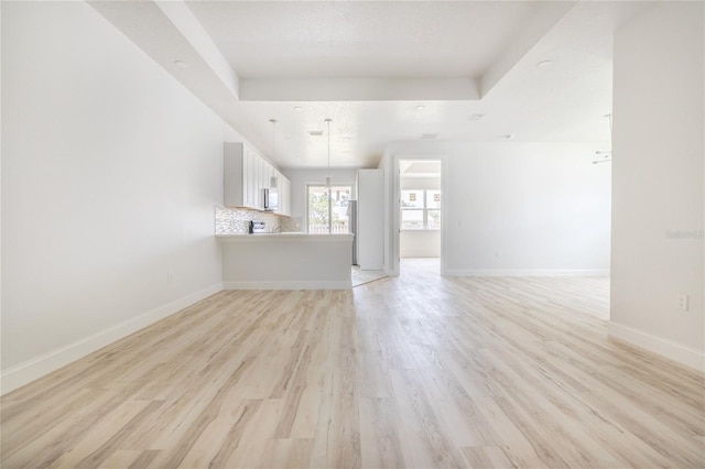 8 Bunker View Pl, Palm Coast, FL 32137 - unfurnished living room with light wood-type flooring and baseboards