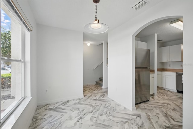 1502 Deer Springs Rd, Port Orange, FL 32129 - corridor featuring light marble finish floors, arched walkways, stairs, and baseboards
