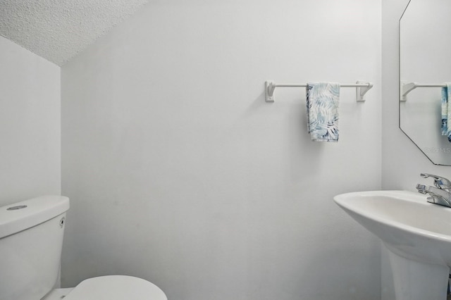 1502 Deer Springs Rd, Port Orange, FL 32129 - bathroom with a sink, toilet, and a textured ceiling