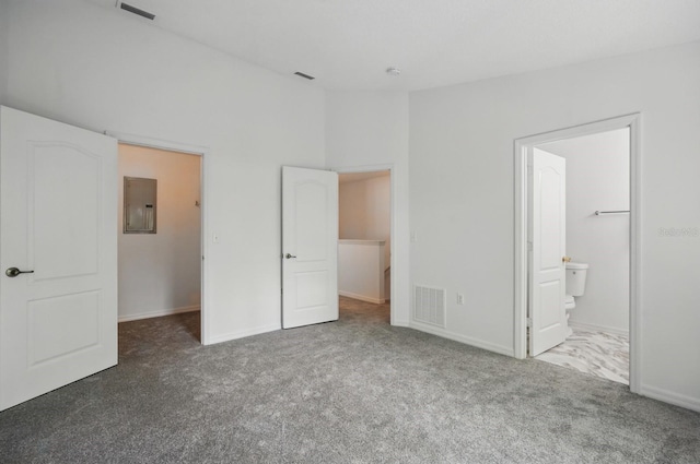 1502 Deer Springs Rd, Port Orange, FL 32129 - unfurnished bedroom featuring electric panel, carpet floors, baseboards, a walk in closet, and ensuite bath