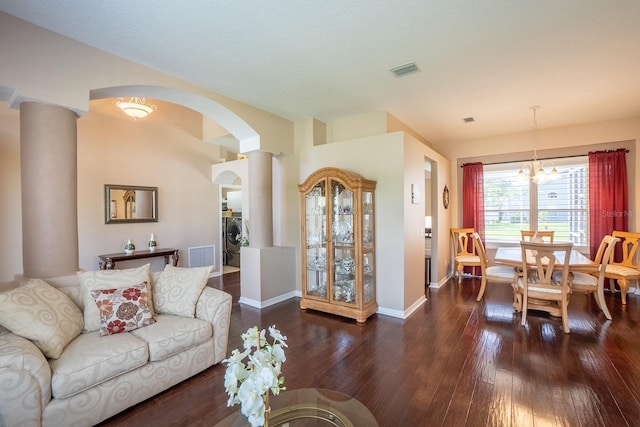 30 Westridge Ln, Palm Coast, FL 32164 - living room with arched walkways, dark wood finished floors, baseboards, a chandelier, and washer / clothes dryer