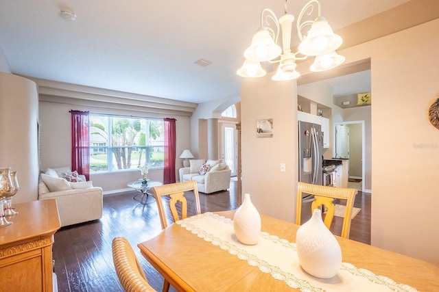 30 Westridge Ln, Palm Coast, FL 32164 - dining room featuring a chandelier, dark wood finished floors, arched walkways, and baseboards