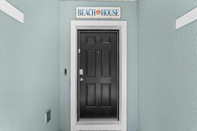3828 S Atlantic Ave, Daytona Beach, FL 32118 - view of exterior entry featuring stucco siding