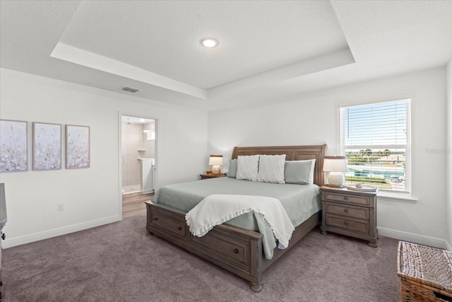 3828 S Atlantic Ave, Daytona Beach, FL 32118 - bedroom featuring a tray ceiling, carpet, and ensuite bath