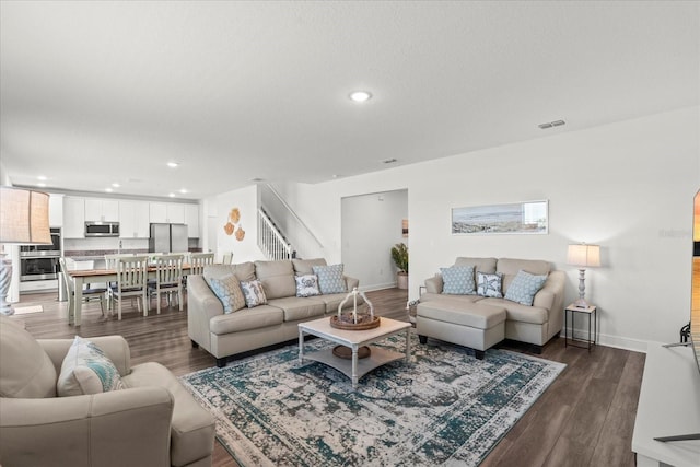 3828 S Atlantic Ave, Daytona Beach, FL 32118 - living room featuring recessed lighting, dark wood-style floors, and stairs
