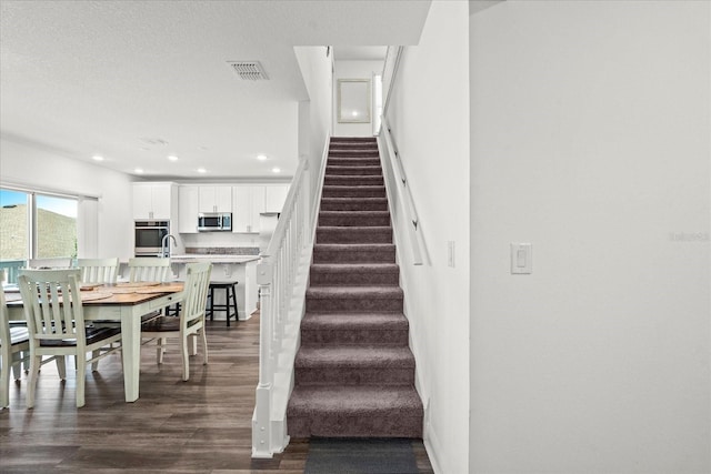 3828 S Atlantic Ave, Daytona Beach, FL 32118 - staircase with wood finished floors and recessed lighting