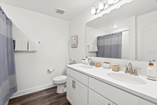 3828 S Atlantic Ave, Daytona Beach, FL 32118 - full bath featuring wood finished floors, double vanity, and curtained shower
