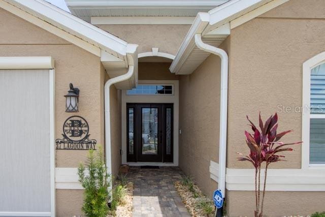 37 Lagoon Way, Palm Coast, FL 32137 - entrance to property featuring stucco siding