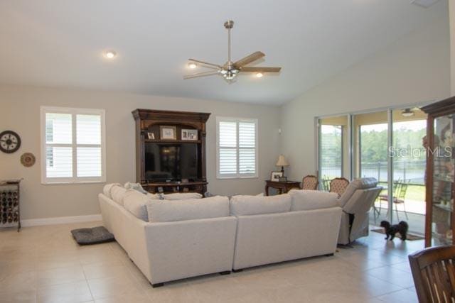 37 Lagoon Way, Palm Coast, FL 32137 - living room with lofted ceiling, ceiling fan, light tile patterned flooring, and baseboards