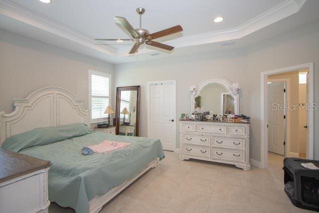 37 Lagoon Way, Palm Coast, FL 32137 - bedroom with a raised ceiling, ornamental molding, recessed lighting, ceiling fan, and light tile patterned floors