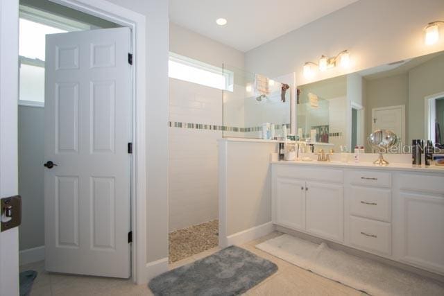 37 Lagoon Way, Palm Coast, FL 32137 - bathroom featuring walk in shower and double vanity