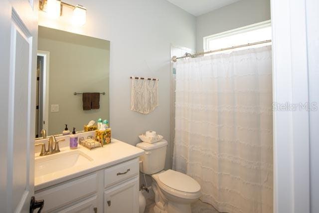 37 Lagoon Way, Palm Coast, FL 32137 - full bathroom featuring vanity, toilet, and curtained shower