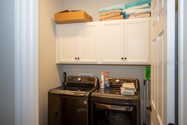 37 Lagoon Way, Palm Coast, FL 32137 - laundry area featuring cabinet space and washing machine and clothes dryer