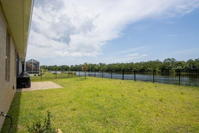 37 Lagoon Way, Palm Coast, FL 32137 - view of yard with a water view and a patio