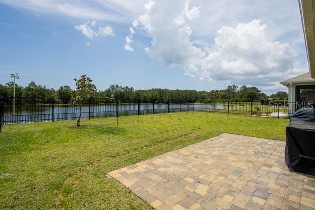 37 Lagoon Way, Palm Coast, FL 32137 - view of yard featuring a water view and a patio