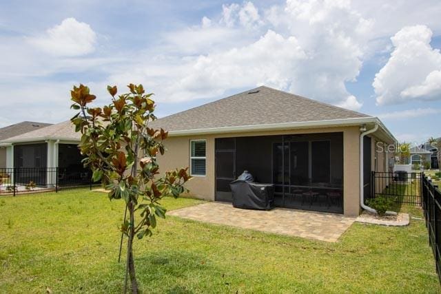 37 Lagoon Way, Palm Coast, FL 32137 - back of property with a sunroom, a patio area, stucco siding, and roof with shingles