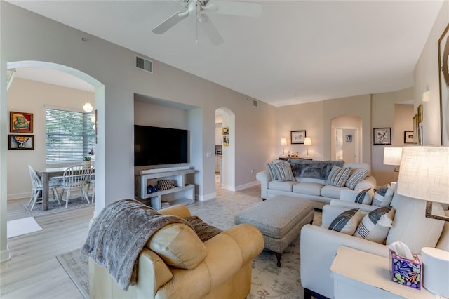 200 Riverfront Dr Unit B204, Palm Coast, FL 32137 - living area with arched walkways, a ceiling fan, baseboards, and light wood finished floors