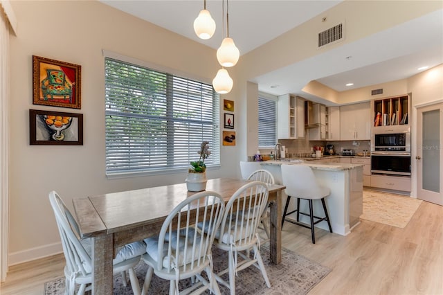 200 Riverfront Dr Unit B204, Palm Coast, FL 32137 - dining room featuring light wood-style flooring and baseboards