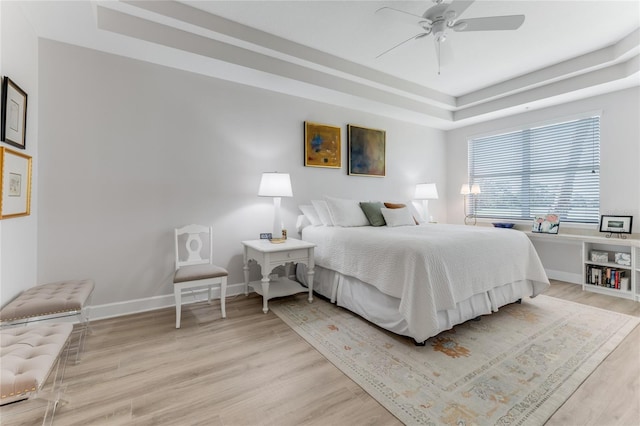 200 Riverfront Dr Unit B204, Palm Coast, FL 32137 - bedroom with a raised ceiling, light wood-type flooring, baseboards, and ceiling fan