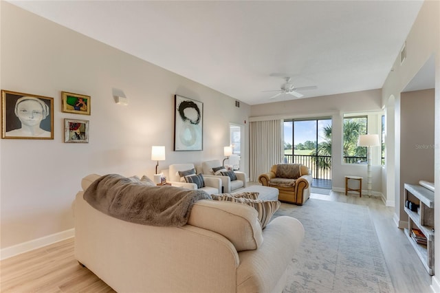 200 Riverfront Dr Unit B204, Palm Coast, FL 32137 - living room with a ceiling fan, baseboards, and light wood-style flooring