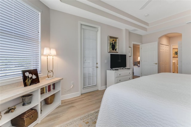 200 Riverfront Dr Unit B204, Palm Coast, FL 32137 - bedroom featuring light wood-style flooring, arched walkways, baseboards, and ceiling fan
