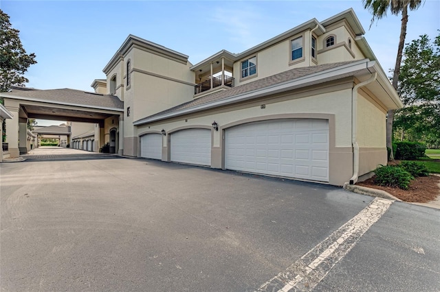 200 Riverfront Dr Unit B204, Palm Coast, FL 32137 - view of front of home with stucco siding, asphalt driveway, and roof with shingles