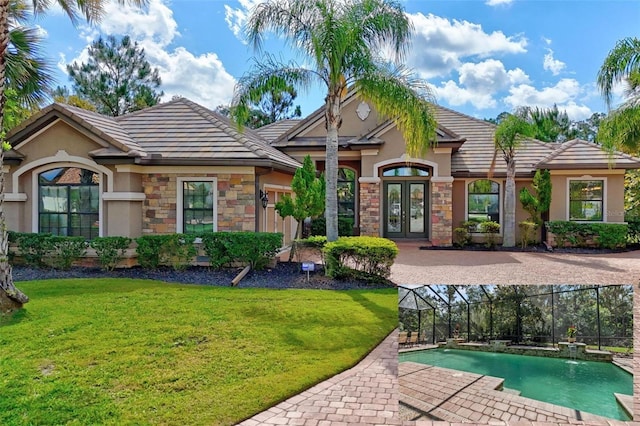 716 Woodbridge Ct, Ormond Beach, FL 32174 - rear view of property with french doors, a tile roof, and stucco siding