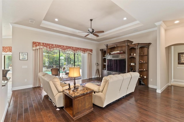 716 Woodbridge Ct, Ormond Beach, FL 32174 - living area with a ceiling fan, a tray ceiling, dark wood finished floors, crown molding, and baseboards