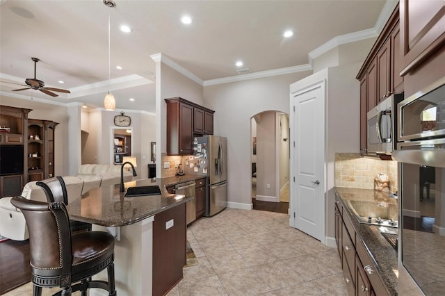 716 Woodbridge Ct, Ormond Beach, FL 32174 - kitchen with a sink, arched walkways, ornamental molding, a ceiling fan, and backsplash