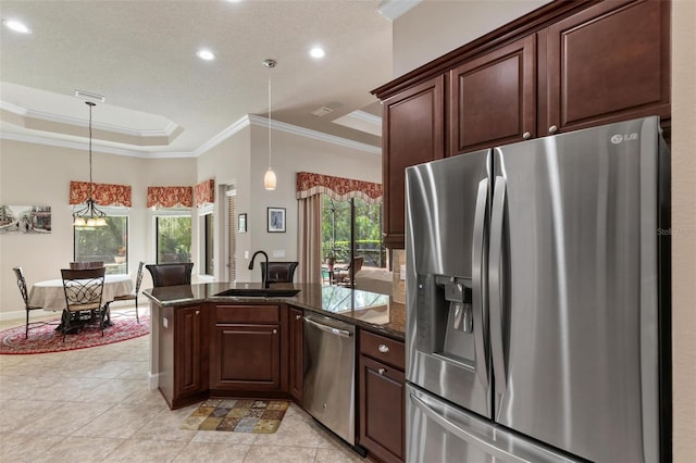 716 Woodbridge Ct, Ormond Beach, FL 32174 - kitchen with appliances with stainless steel finishes, a raised ceiling, a sink, ornamental molding, and dark stone countertops