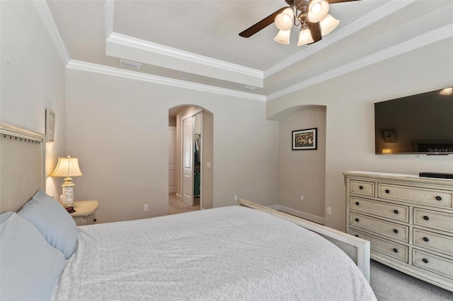 716 Woodbridge Ct, Ormond Beach, FL 32174 - bedroom featuring arched walkways, a raised ceiling, crown molding, carpet flooring, and a ceiling fan