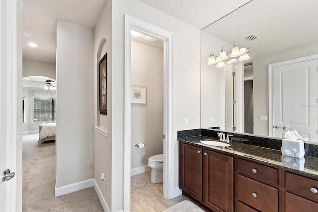 716 Woodbridge Ct, Ormond Beach, FL 32174 - bathroom featuring toilet, vanity, ensuite bath, baseboards, and a ceiling fan