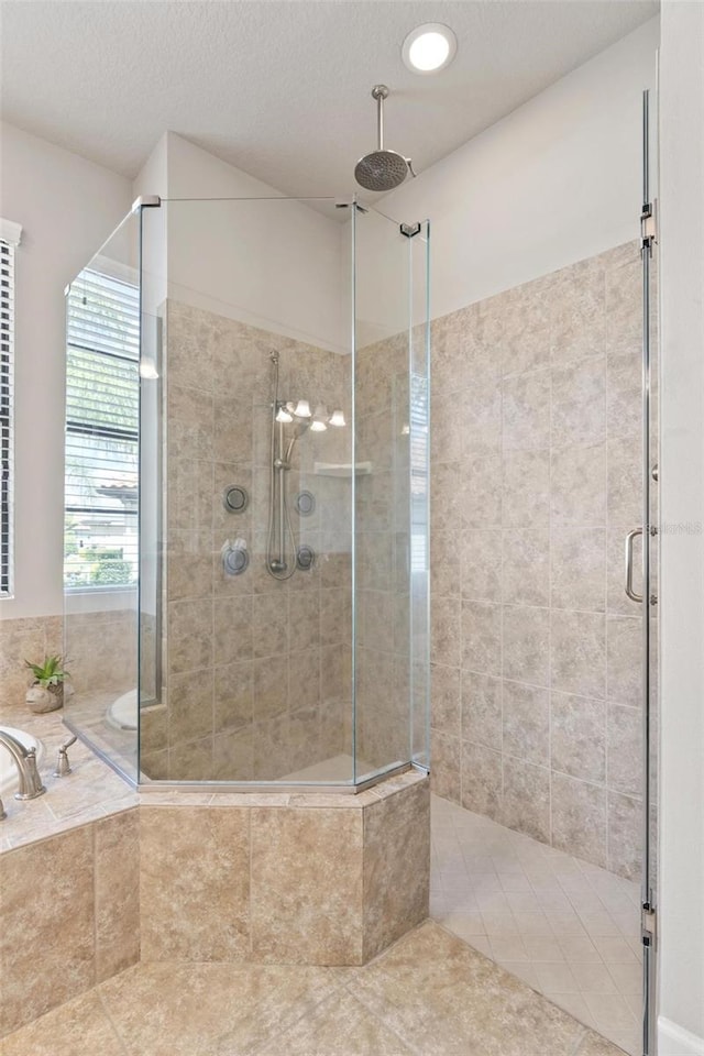 716 Woodbridge Ct, Ormond Beach, FL 32174 - bathroom featuring a shower stall, a bath, and tile patterned flooring