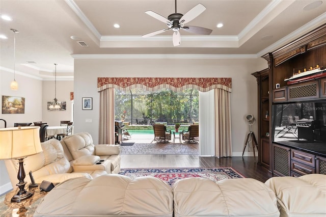 716 Woodbridge Ct, Ormond Beach, FL 32174 - living room featuring a tray ceiling, dark wood-style flooring, a ceiling fan, crown molding, and baseboards