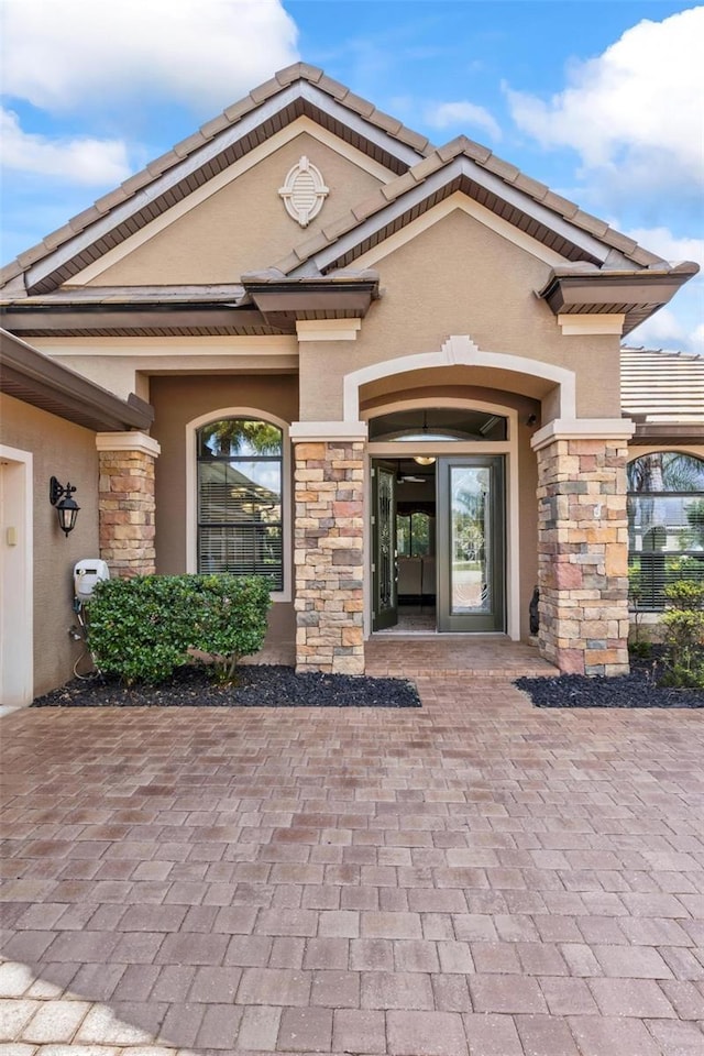716 Woodbridge Ct, Ormond Beach, FL 32174 - property entrance featuring stone siding and stucco siding