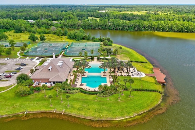 716 Woodbridge Ct, Ormond Beach, FL 32174 - bird's eye view of a pool area, a forest, and a nearby body of water